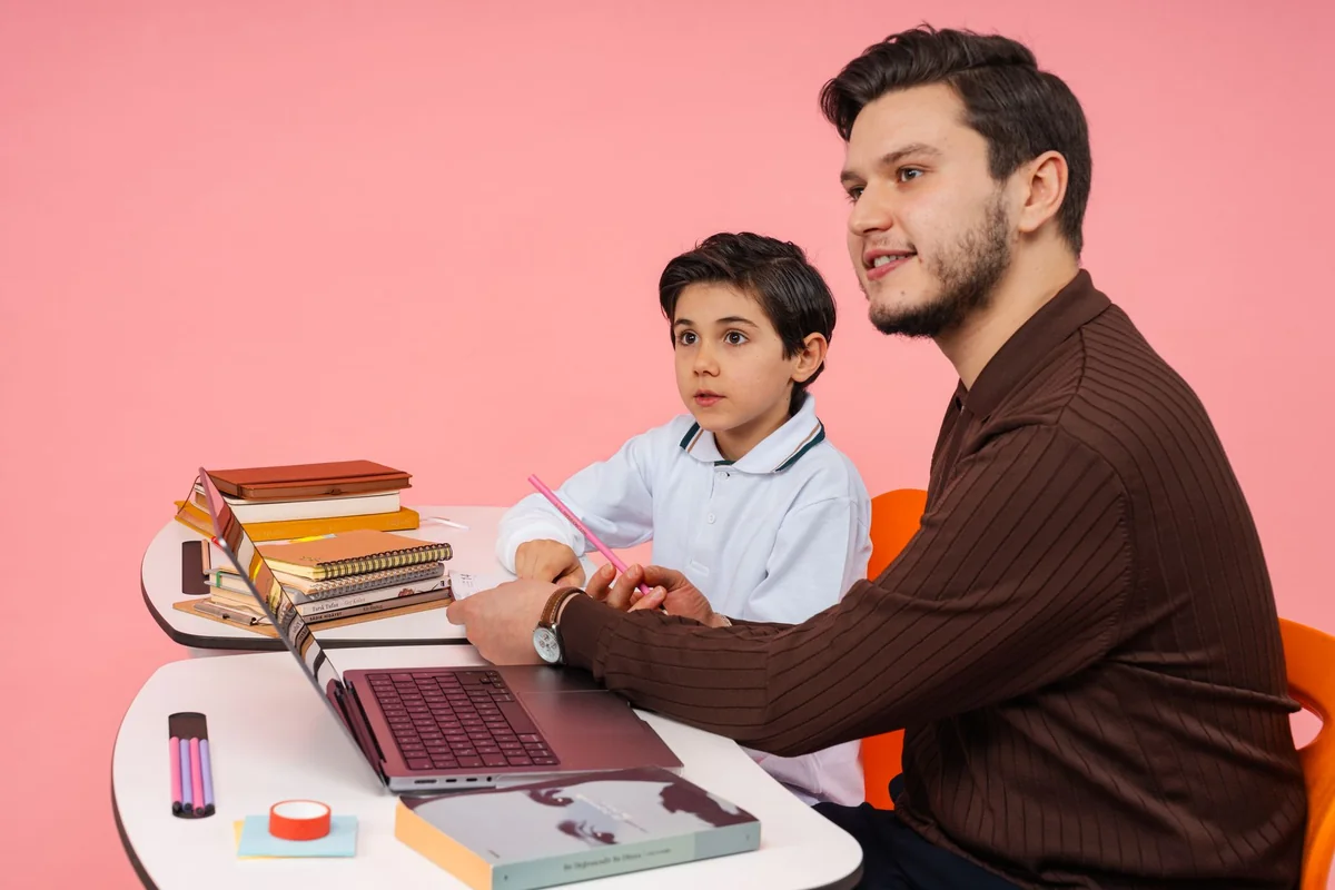 Male teacher and young boy studying together at a desk in Yalova, Türkiye.